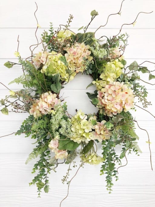 Handcrafted pink and green hydrangea wreath for spring door decor. Shop unique floral wreaths on Etsy.
