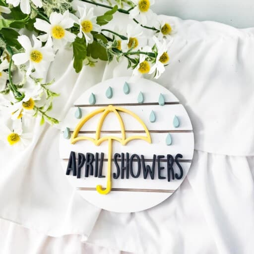 Handcrafted 'April Showers' sign on rustic shiplap. Decorate your home with a touch of spring! Shop similar signs on Etsy.