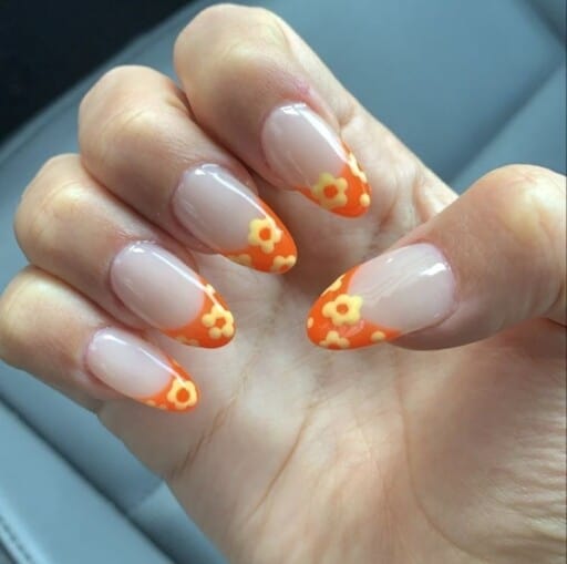 delicate and abstract flower nail art designs: Orange Flower Tips