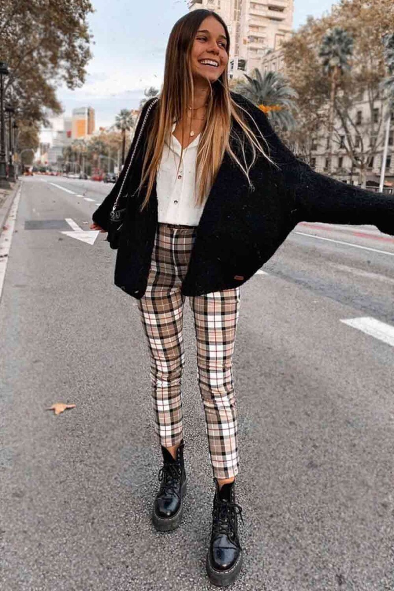 Cute red and black plaid pants with comfy black knit sweater and trendy  leather boots.