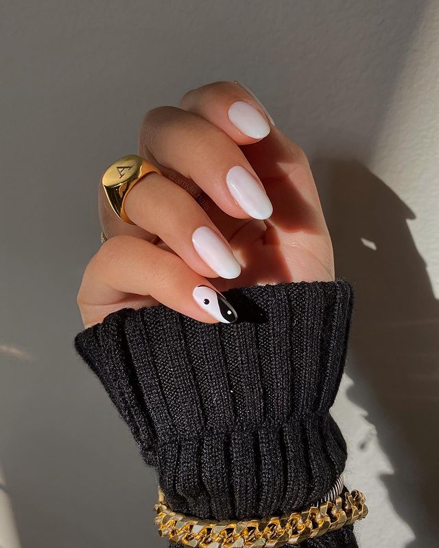 black and white nails with gold rhinestones